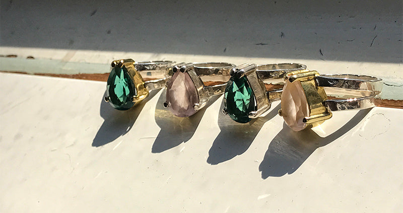 group of teardrop quartz and silver rings 