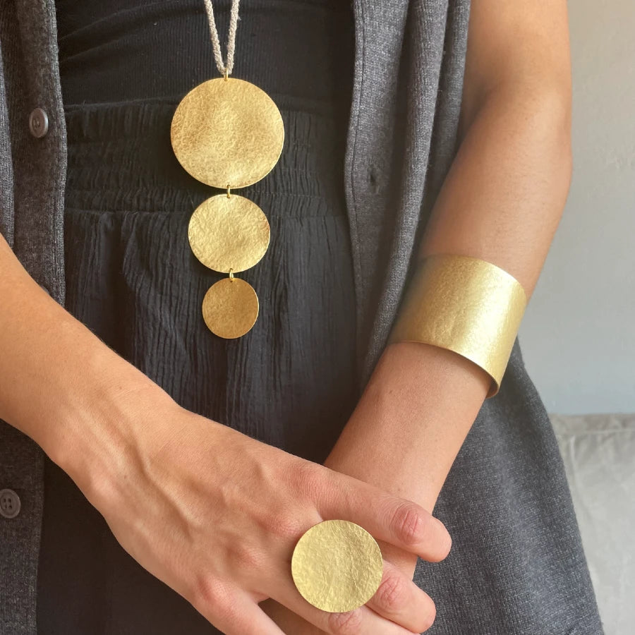 wide gold cuff with accessories